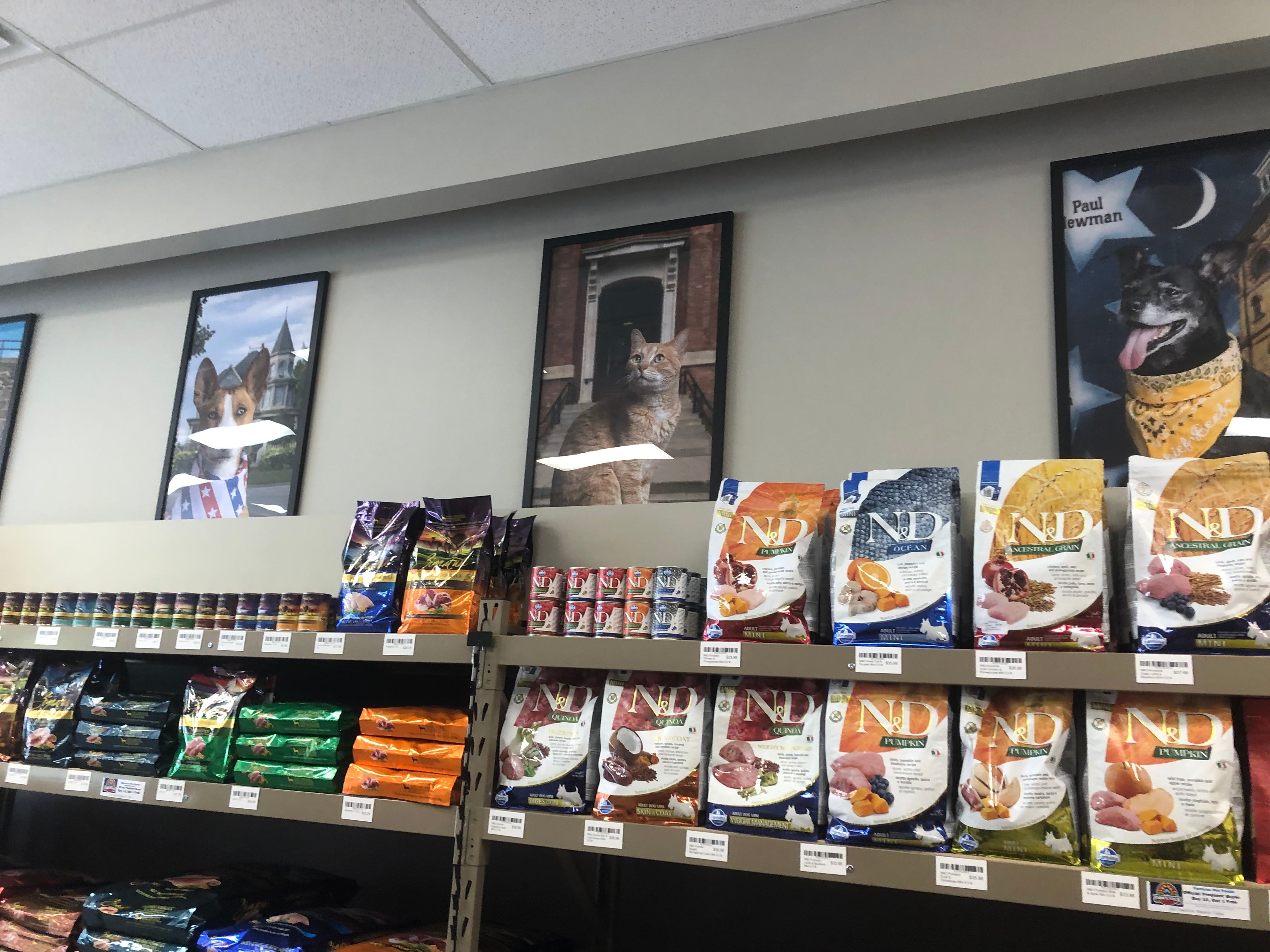 Pet food and pet photos line the wall at Pawstock in Woodstock Aug. 1, 2024.