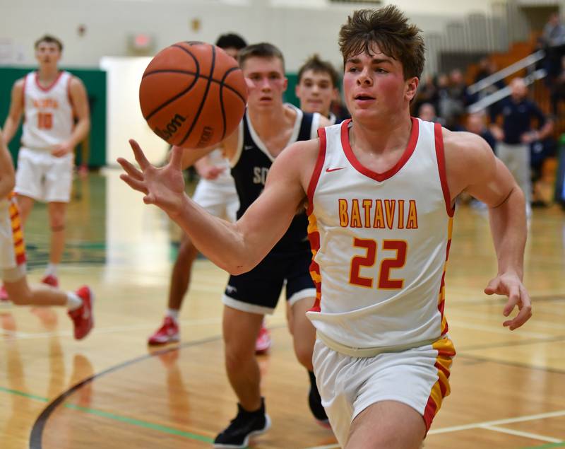 Batavia's Charlie Whelpley (22) saves the ball from going out of bounds during a Jack Tosh Classic game against Downers Grove South on Dec. 26, 2023 at York High School in Elmhurst.