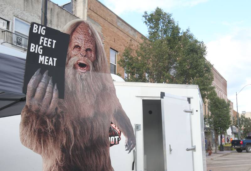 A large cutout of Big Foot reads "Big Feet Big Meat" during the BBQ and Blues festival on Friday, Sept. 13, 2024 downtown La Salle.