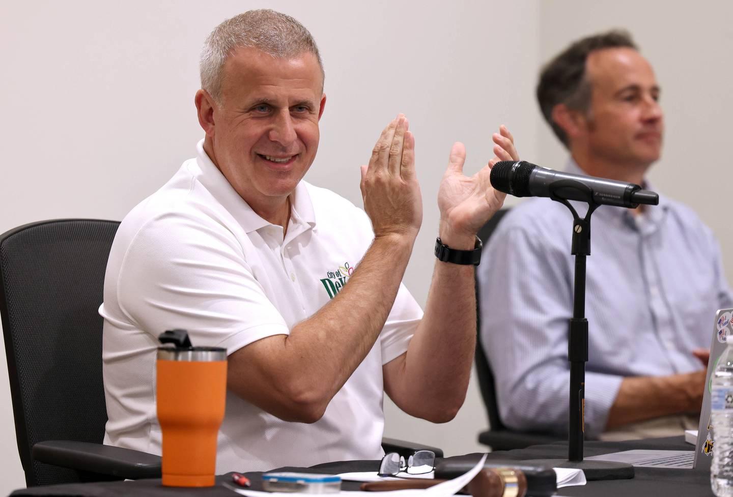 DeKalb Mayor Cohen Barnes applauds Monday, July 10, 2023, during the DeKalb City Council meeting after the council passed a resolution to enter into a redevelopment