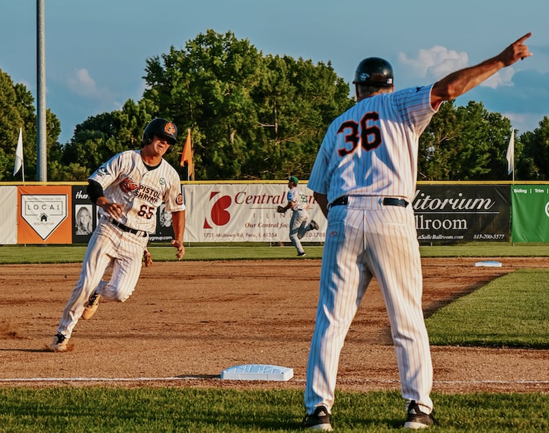 Kyle Gibson gets waved home by manager John Jakiemiec in the first inning of the Illinois Valley Pistol Shrimp's 3-0 victory over the Clinton LumberKings in the Prospect League Northwest Division title game on Thursday, August 1, 2024, at Schweickert Stadium in Peru.