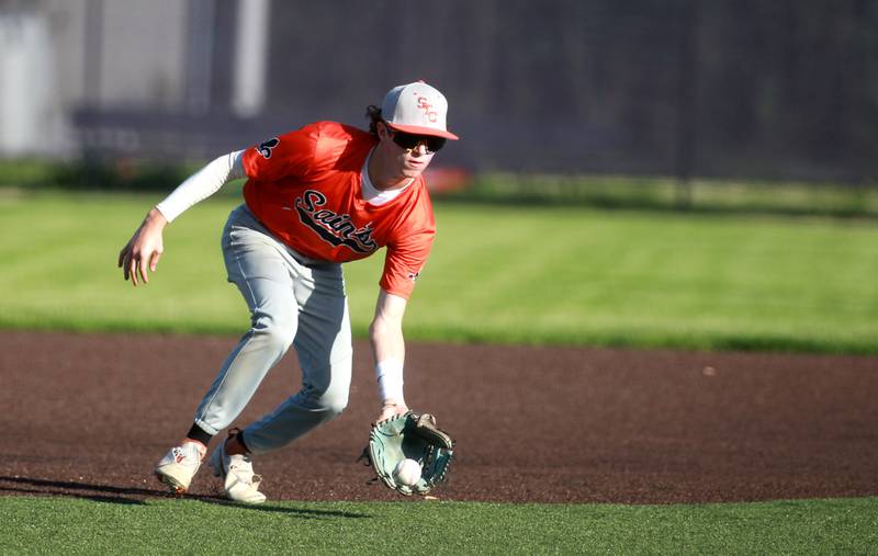 St. Charles East’s Jake Greenspa scoops up a ground ball during a game against Geneva at Judson University in Elgin on Tuesday, May 7, 2024.