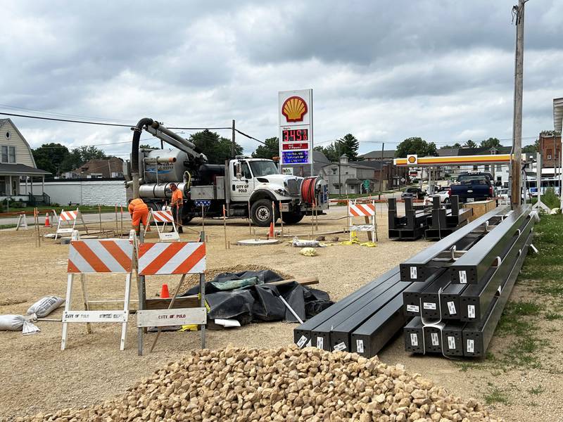 Polo city employees work to prepare the city-owned lot at 212 S. Division Ave. for the erection of two pavilions.