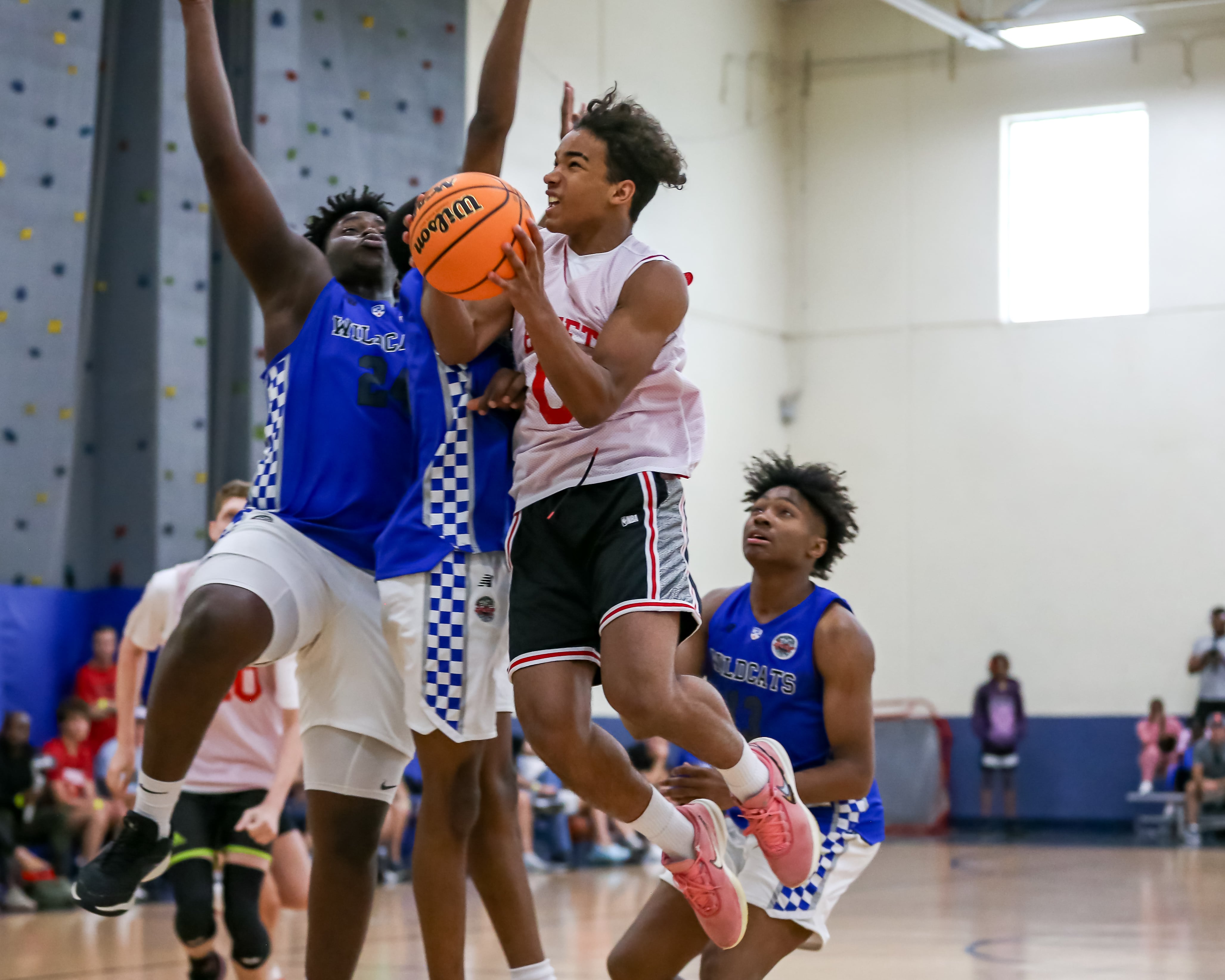 Benet's Blake Fagbemi (0) hangs in the air under the basket at the Riverside-Brookfield Summer Shootout basketball tournament.