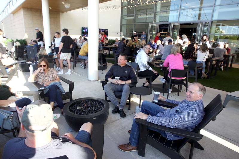 Visitors enjoy the weather during a patio launch party at Pickle Haus in Algonquin Friday night.