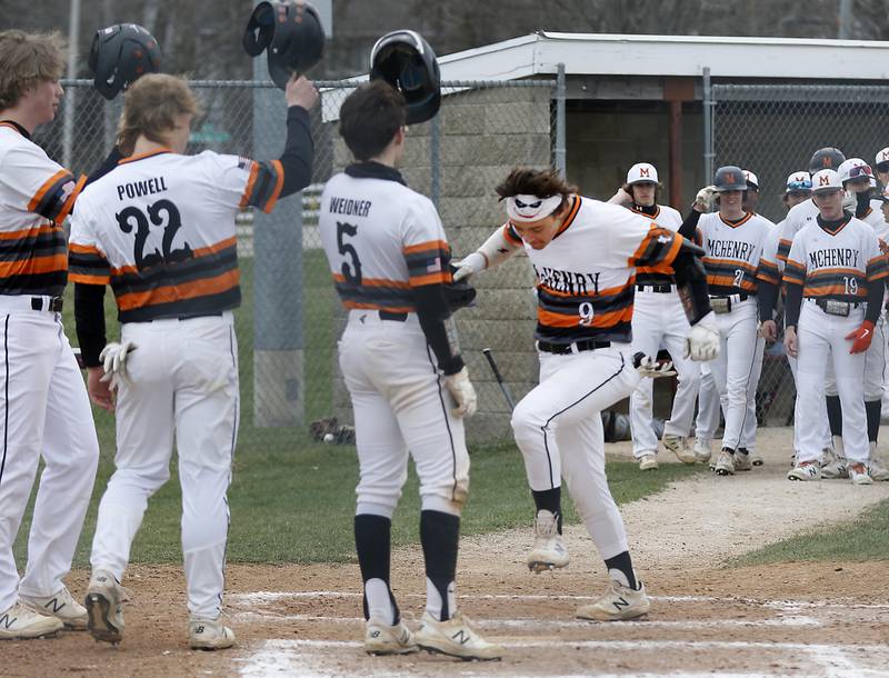 McHenry's Cooper Cohn stomps in home plate after hitting a three-run home run during a Fox Valley Conference baseball game Friday, April 15, 2022, between Jacobs and McHenry at Petersen Park in McHenry.