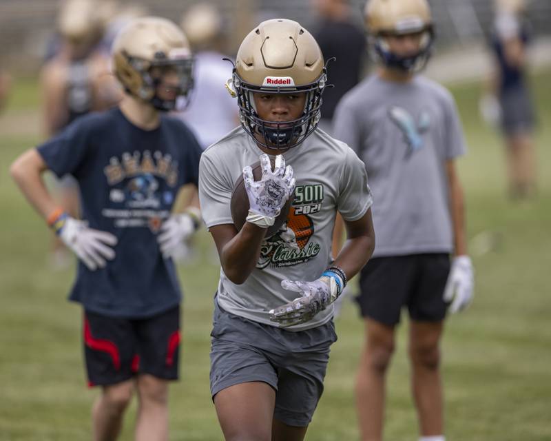 Conor Baker of Marquette High School runs rushing drills on opening practice day at the Marquette High School practice field on August 12, 2024.