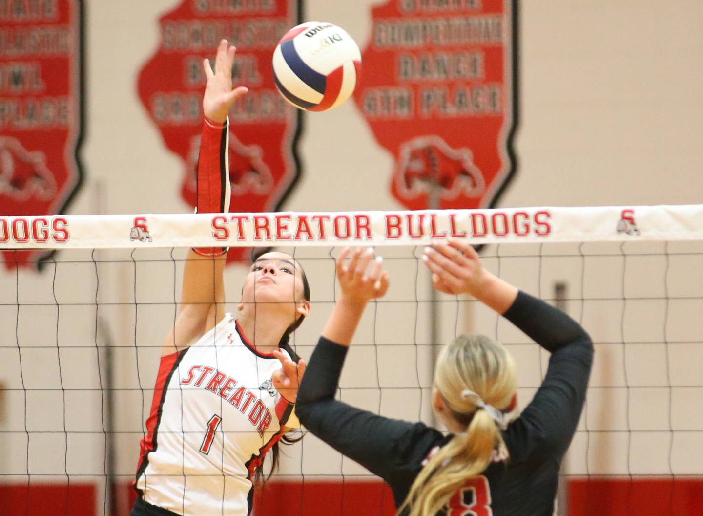 Streator's Aubrey Jacobs spikes the ball over Woodland's Grace Longmire on Monday, Aug. 26, 2024 at Streator High School.