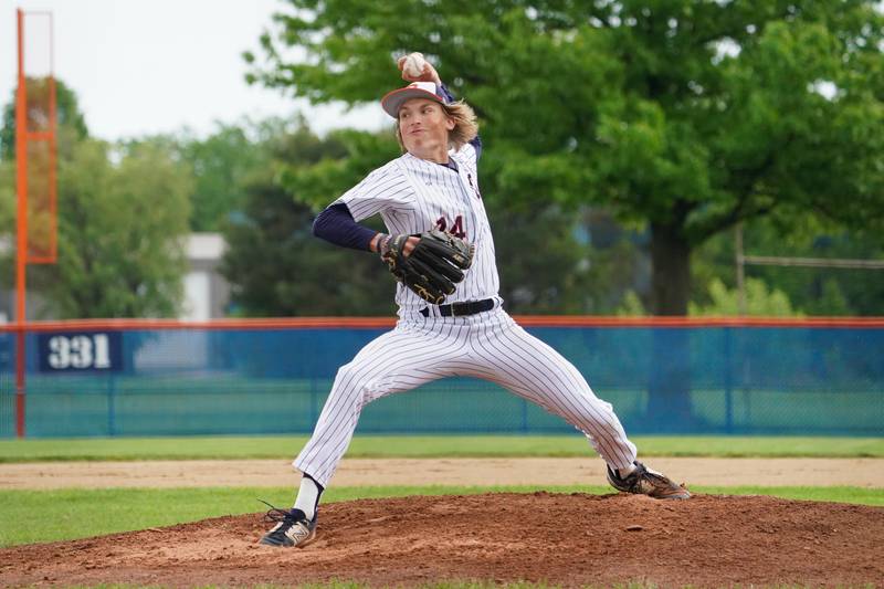 Oswego’s Noah Mottet (14) delivers a pitch against Oswego East during a baseball game at Oswego High School on Monday, May 13, 2024.