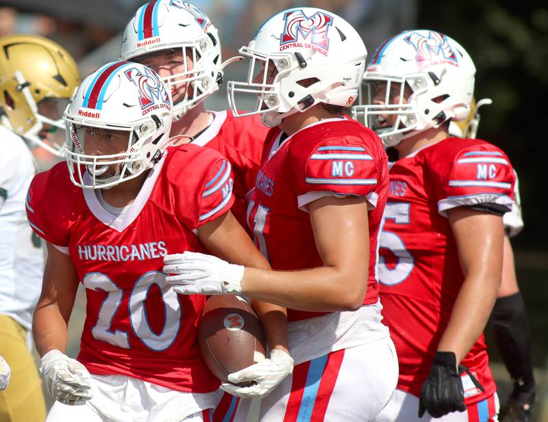 Marian Central’s Nicholas Schmid, left, is greeted in the end zone on a touchdown against Bishop McNamara in varsity football action on Saturday, Sept. 14, 2024, at George Harding Field on the campus of Marian Central High School in Woodstock.