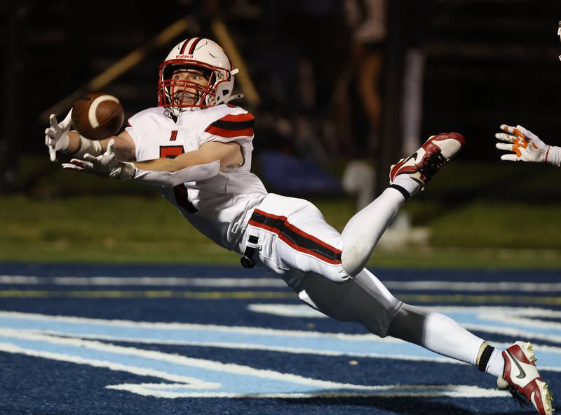 Benet's Luke Doyle (7) lays out for a pass during the varsity football game between Benet and Nazareth academies on Friday, Oct. 18, 2024 in La Grange Park.