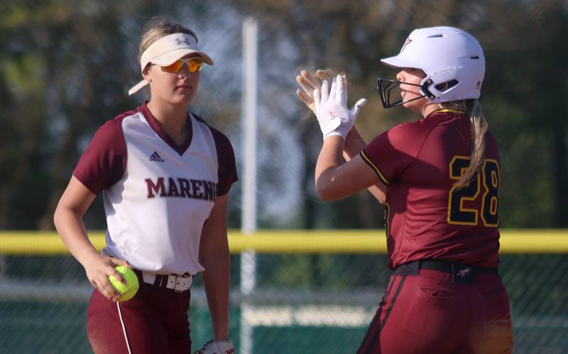 Richmond-Burton’s Madison Kunzer, right, celebrates arriving at second base with a double  in varsity softball at Marengo Monday.