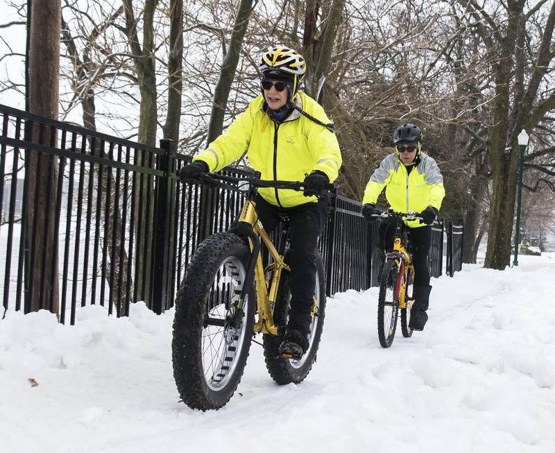 Pam (left) and BJ Fenwick ride along East Boyd Street in Dixon during the New Year's Day bike ride Jan. 1, 2021.