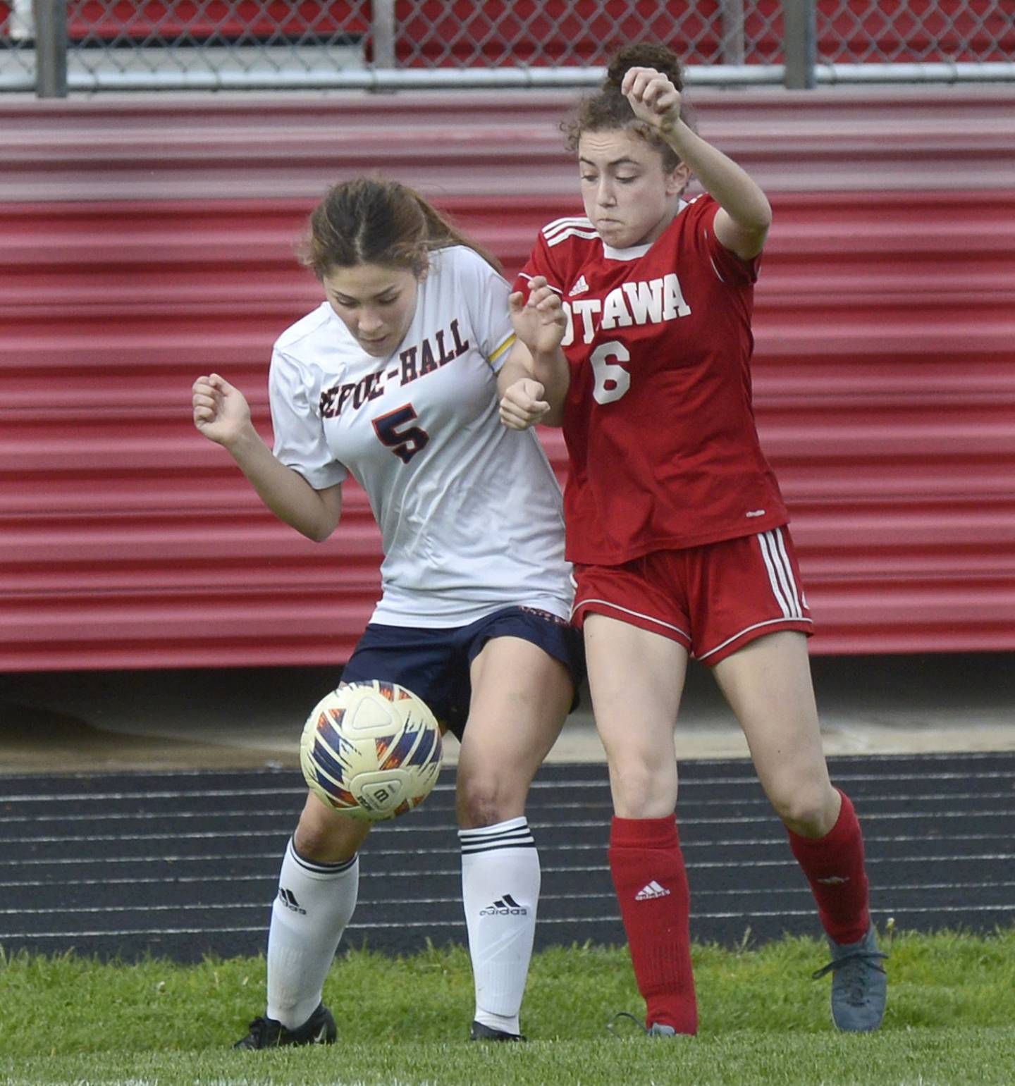 Ottawa’s Kindley Moore (6) and DePue/Hall’s Veronica Fitzgerald (5) fight for control of the ball during their match Thursday at Ottawa.
