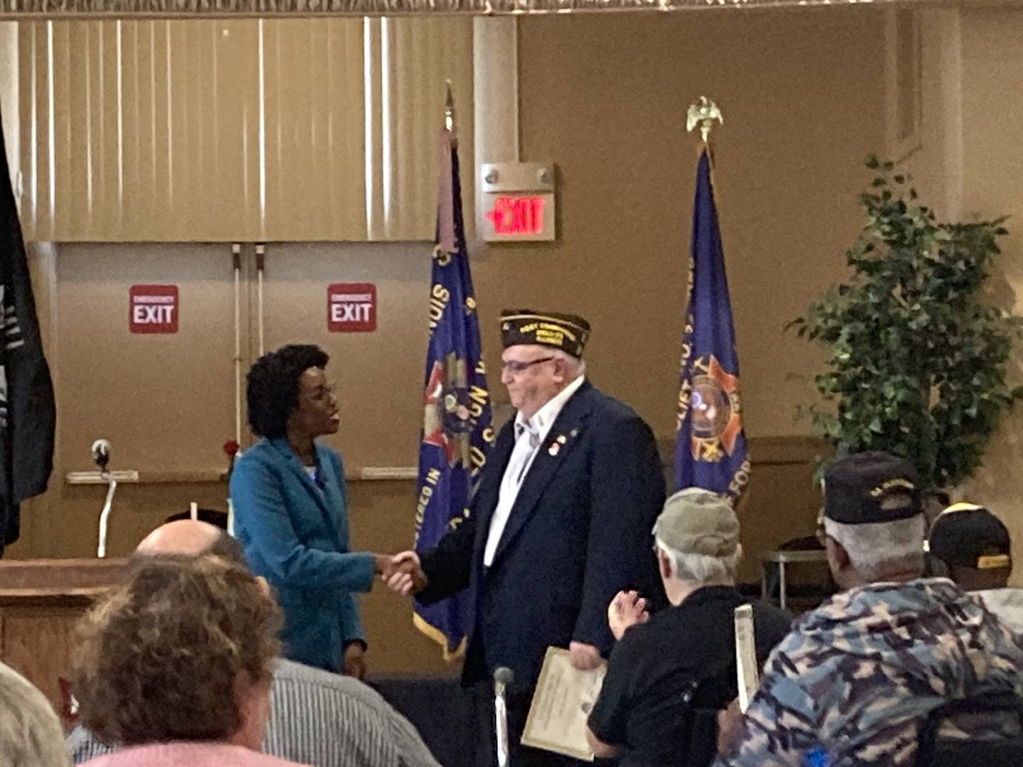 Representative Lauren Underwood shakes hands with VFW Post Commander Lou Smith after recognizing him at the VFW pinning ceremony.