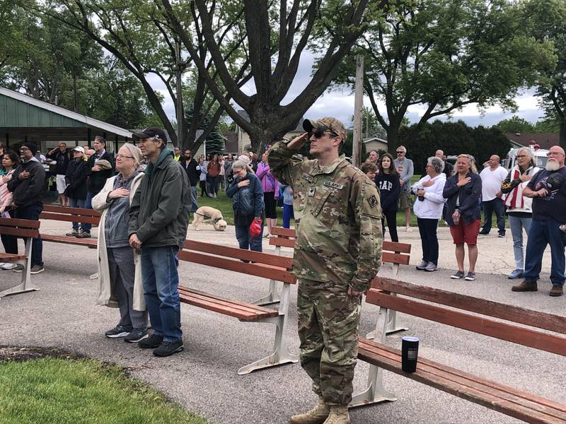 People stand at attention during the Johnsburg Memorial Day closing ceremony Monday May 27, 2024.