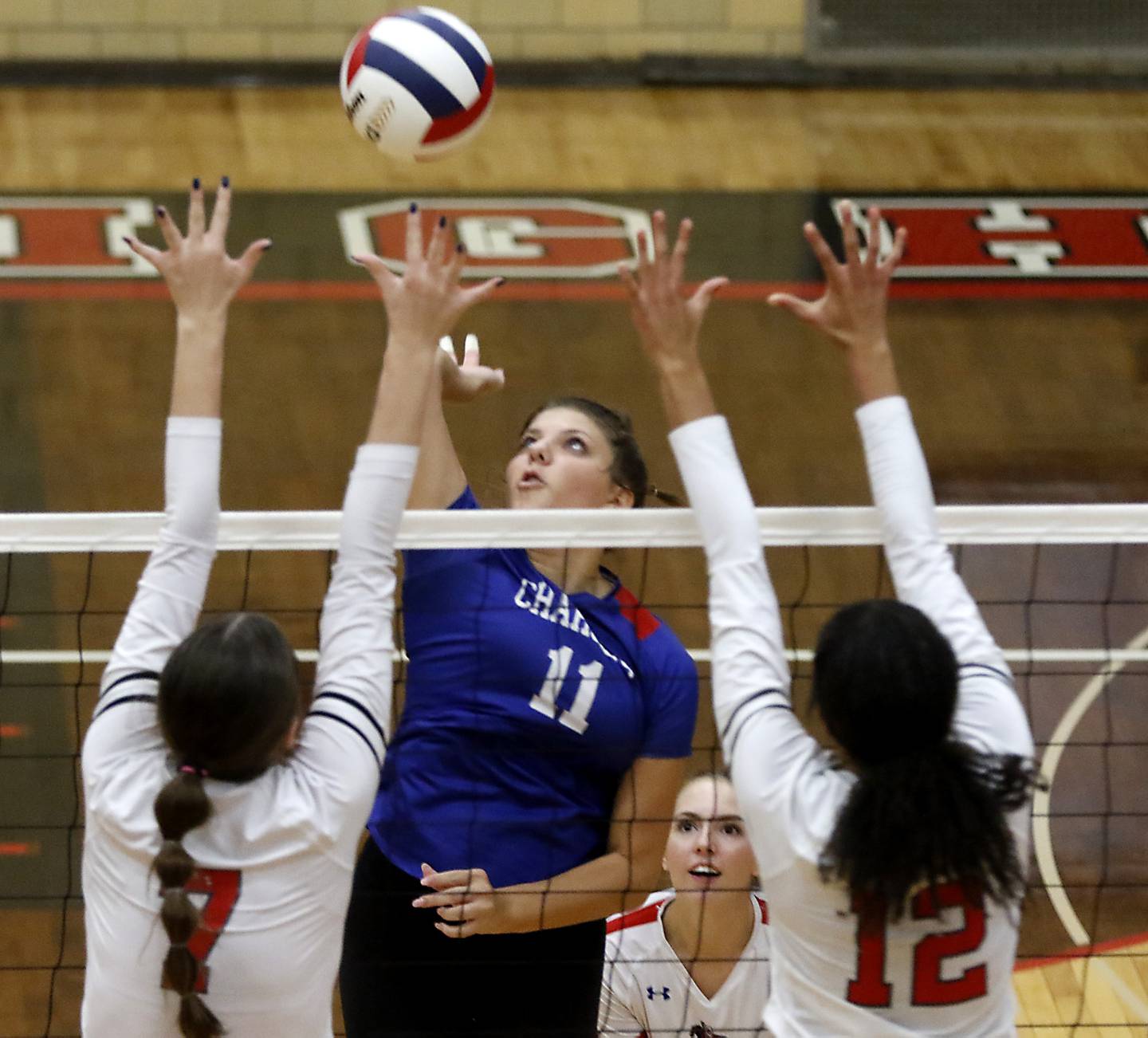 Dundee-Crown's Taylor Findlay tries to hit the ball through the block of Huntley's Jocelyn Erling (left) and Morgan Jones during the IHSA Class 4A Rockford East Regional Volleyball Championship match on Thursday, Oct. 26, 2023, at Rockford East High School.