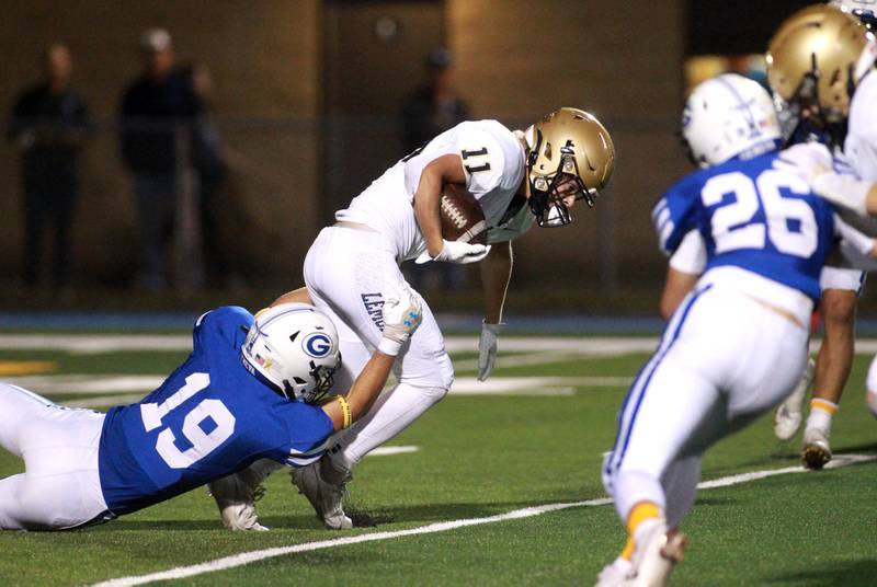 Lemont’s Cole Johnson is tackled by Geneva’s Brian Waters during a game Friday, Sept. 6, 2024 at Geneva.