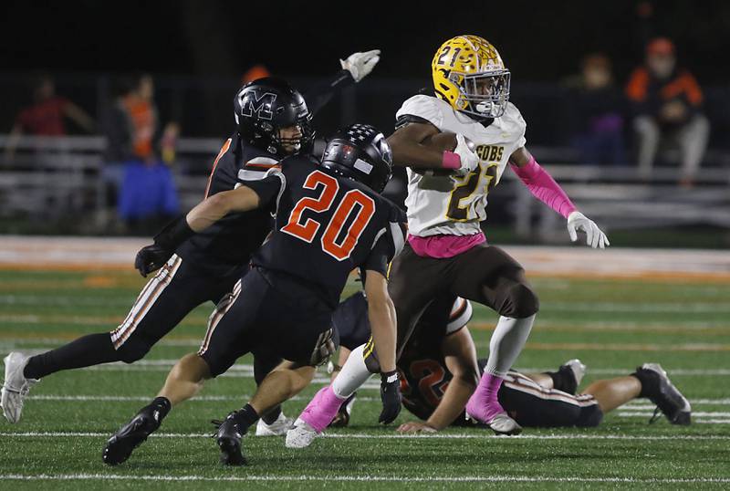 Jacobs' Michael Cannady cuts back as he runs against McHenry's Braydon Stebbins during a Fox Valley Conference football game on Friday, Oct. 18, 2024, at McKracken Field in McHenry.