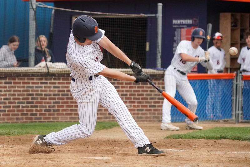 Oswego’s Anthony Comperda (9) drives in a run against Oswego East during a baseball game at Oswego High School on Monday, May 13, 2024.