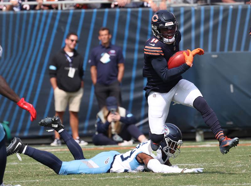 Chicago Bears returner DeAndre Carter jumps away from a tackle attempt by Tennessee Titans cornerback Darrell Baker Jr. during their game Sunday, Sept. 8, 2024, at Soldier Field in Chicago.