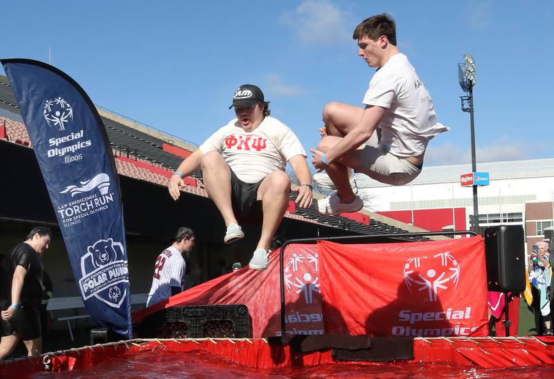 Members of the Phi Kappa Psi fraternity jump into the water on a cold and windy Saturday, Feb 17, 2024, during the Huskie Stadium Polar Plunge at Northern Illinois University in DeKalb. The Polar Plunge is the signature fundraiser for Special Olympics Illinois.