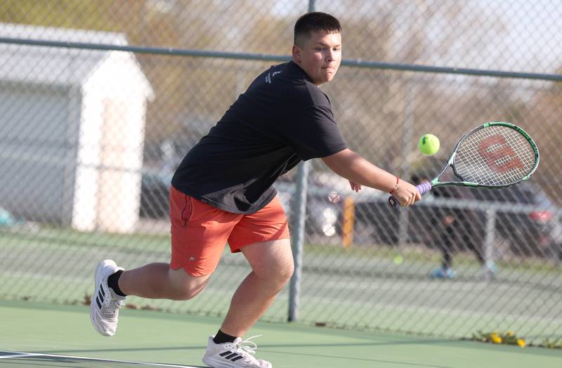 DeKalb number two doubles player Marcos Zaylic reaches for a backhand Wednesday, April 26, 2023, during their match at Sycamore High School.