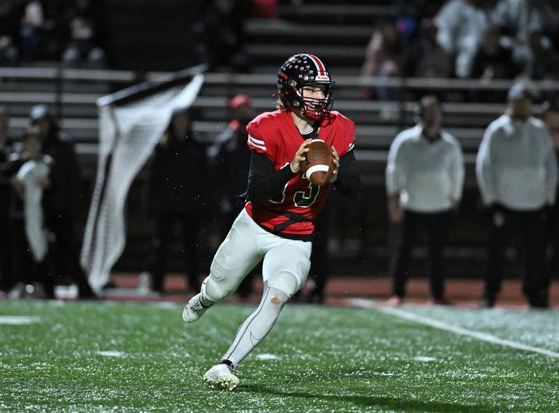 Lincoln-Way Central's Michael Kuehl rolls out to throw a pass during the class 7A first round  playoff game against Jacob on Friday, Oct. 27, 2023, at New Lenox. (Dean Reid for Shaw Local News Network)