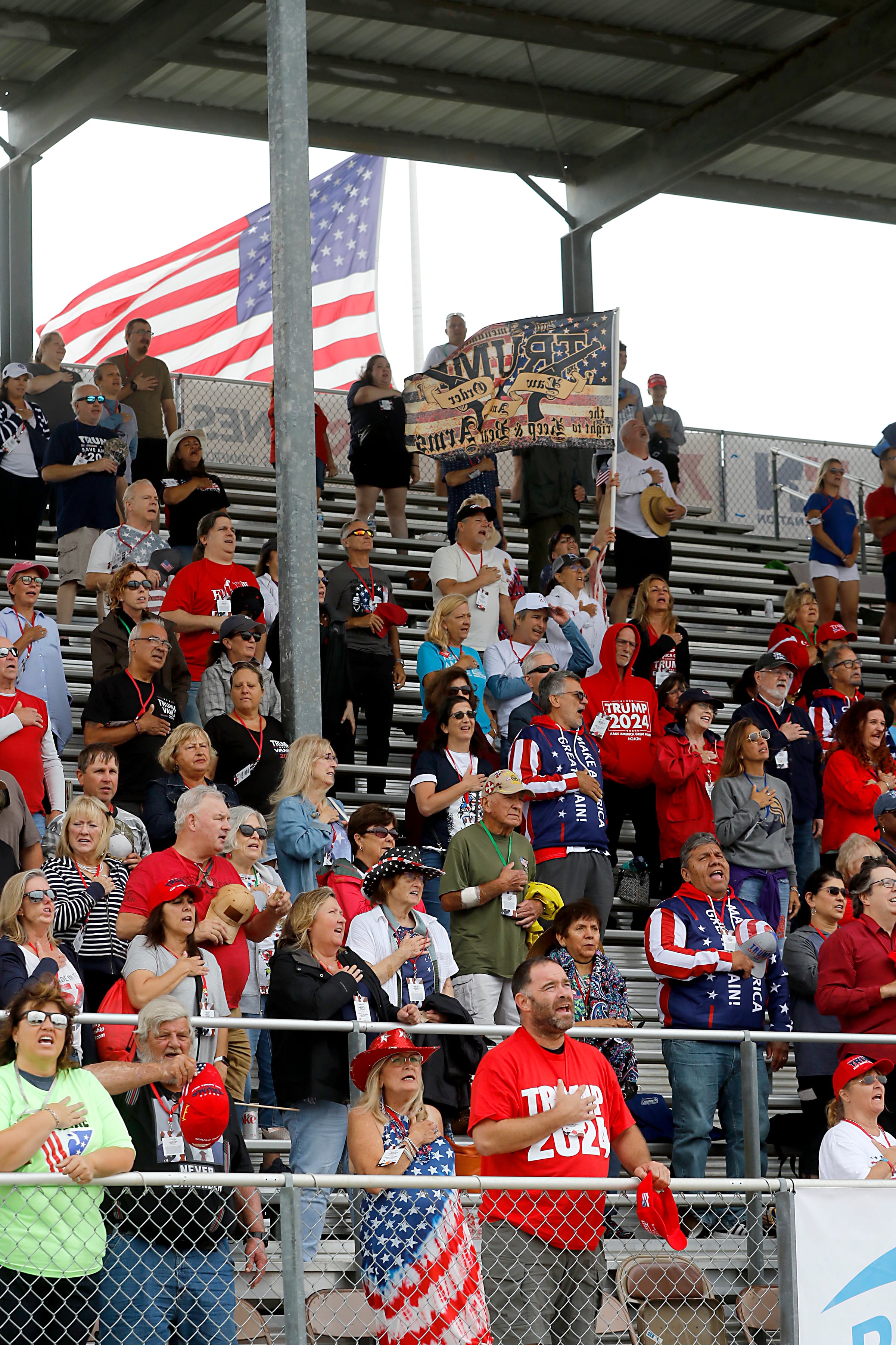 People listen to the “National Anthem” during the Trump Now-Save the American Dream Rally at the McHenry County Fairgrounds on Sunday Aug. 18, 2024, in Woodstock.