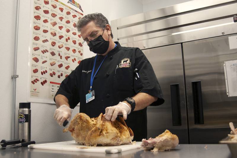 Michael Johnson carves a turkey on Thursday, Nov. 25, 2021, at the PADS shelter at 1805 S. Route 31 McHenry.