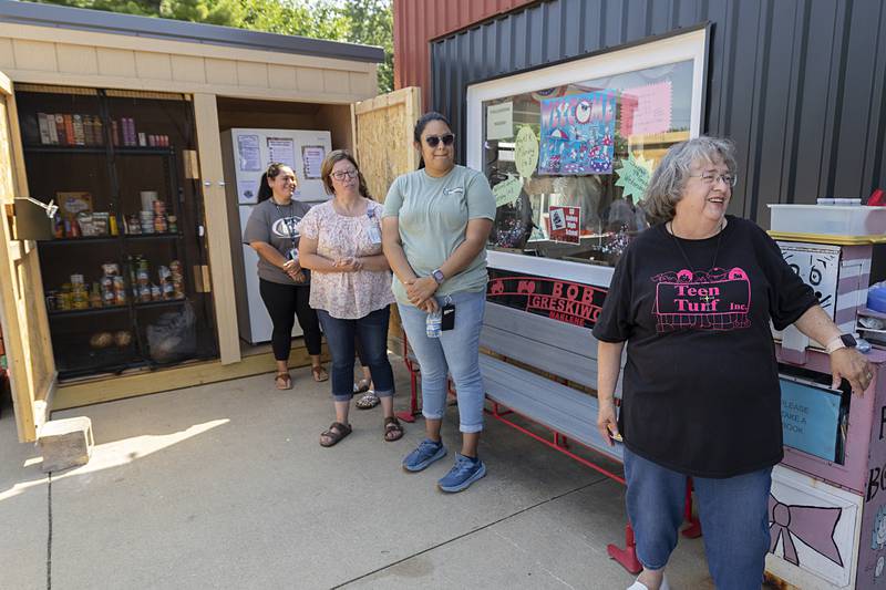 Teen Turf’s Eileen Piper (right) talks about what the mini food mart means to the Amboy community Thursday, June 20, 2024.