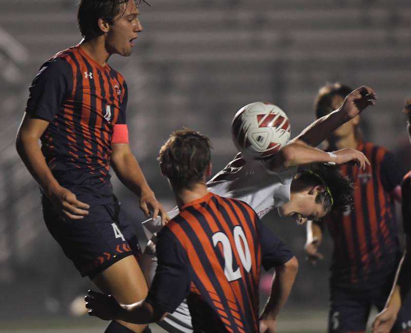 Oswego’s Ryan Walsh knocks down Naperville Central’s Eric Sonnenschein in the Class 3A Plainfield North High School boys soccer sectional semifinal game in Plainfield on Wednesday, October 25, 2023.