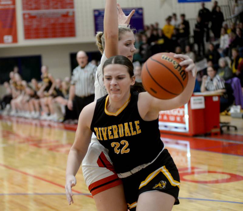 Riverdale's Katie Cox (22) reaches for a loose ball as Stillman Valley's Mya Janssen (13) defends on Tuesday. Feb. 20, 2024 at the 2A Oregon Sectional held at the Blackhawk Center at Oregon High School. The Rams' season ended with a 57-34 loss to the Cardinals.