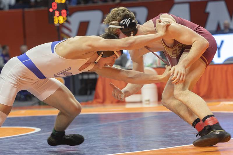 Vernon Hills’ Ilia Dvoriannikov grapples with Dunlap’s Nick Mueller in the 2A 165 pound championship match Saturday, Feb. 17, 2024 at the IHSA state wrestling finals at the State Farm Center in Champaign.