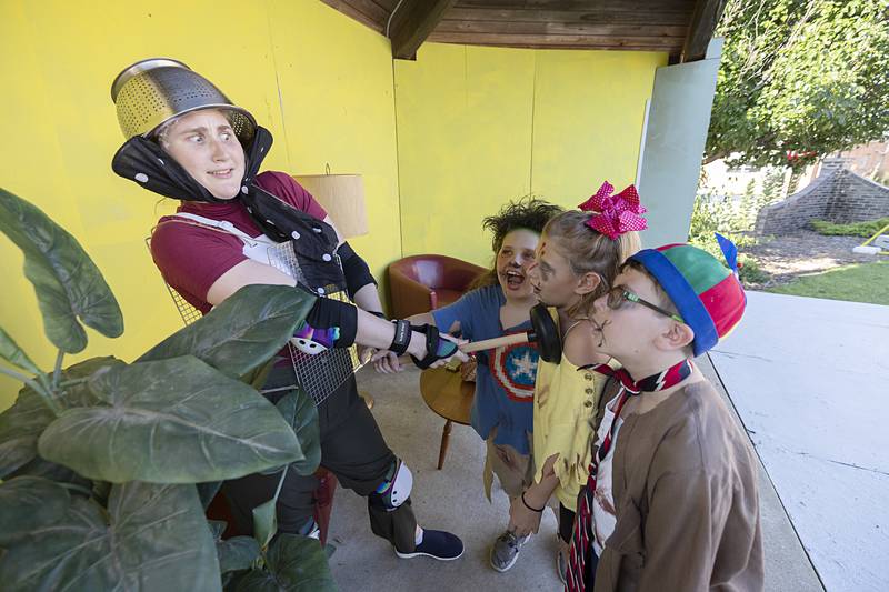 Rhylee Hinkle fights off a horde of zombies played by Jonathan Zell (left), Mady Weilacher and Wesley Diehl during rehearsal Thursday, July 11, 2024 at Louise Quick Park in Polo. Polo Area Community Theatre will perform “How to Hide Your Zombies” on July 12-14 at 7 p.m.