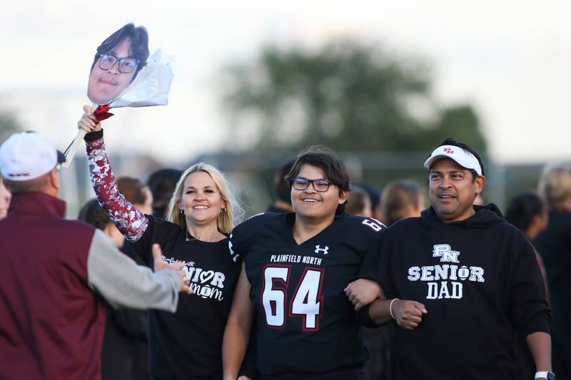 Plainfield North's Joshua Flores (64) is escorted by his parents for senior night before football game between York at Plainfield North on Friday, Sept 6th, 2024 in Plainfield. Gary E Duncan Sr for Shaw Local News Network.