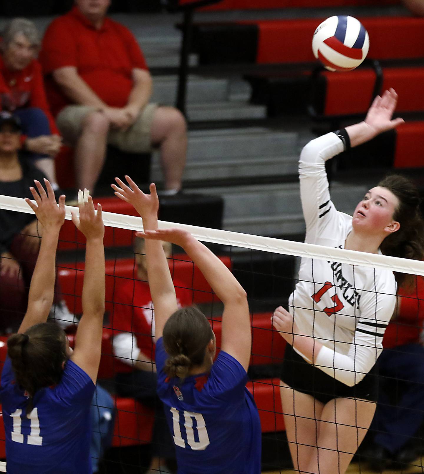 Huntley's Georgia Watson tries to hit the ball past the defense of Dundee-Crown's Taylor Findlay (left) and Coley DiSilvio during the IHSA Class 4A Rockford East Regional Volleyball Championship match on Thursday, Oct. 26, 2023, at Rockford East High School.