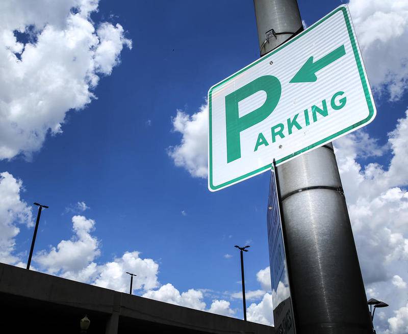 A parking sing hangs on a light pole June 19, 2017, in downtown Joliet.