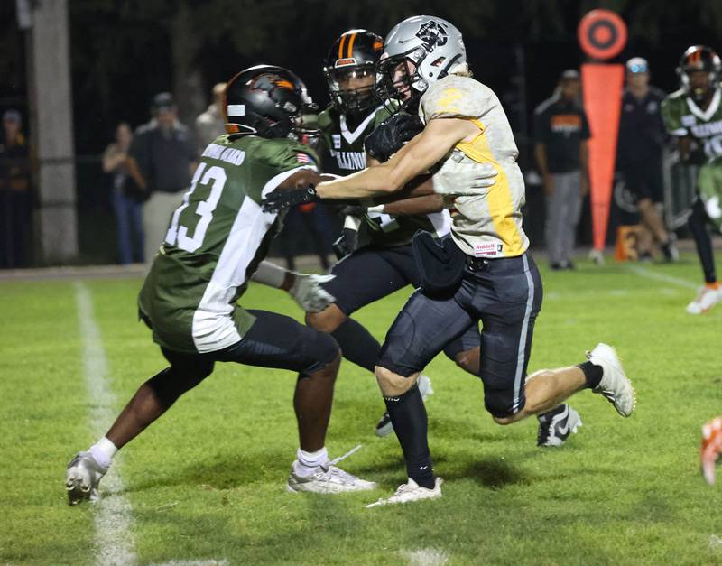 Kaneland's Carter Grabowski tries to get around DeKalb's Davon Grant during their game Friday, Sept. 13, 2024, at Kaneland High School in Maple Park.