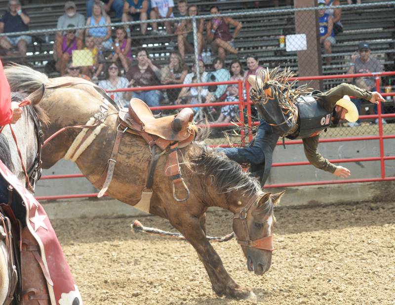 Lane Epperson of Missouri gets tossed from his bucking bronco in the afternoon session of the Big hat Rodeo at the Ogle County Fair on Friday, Aug. 4 2023.