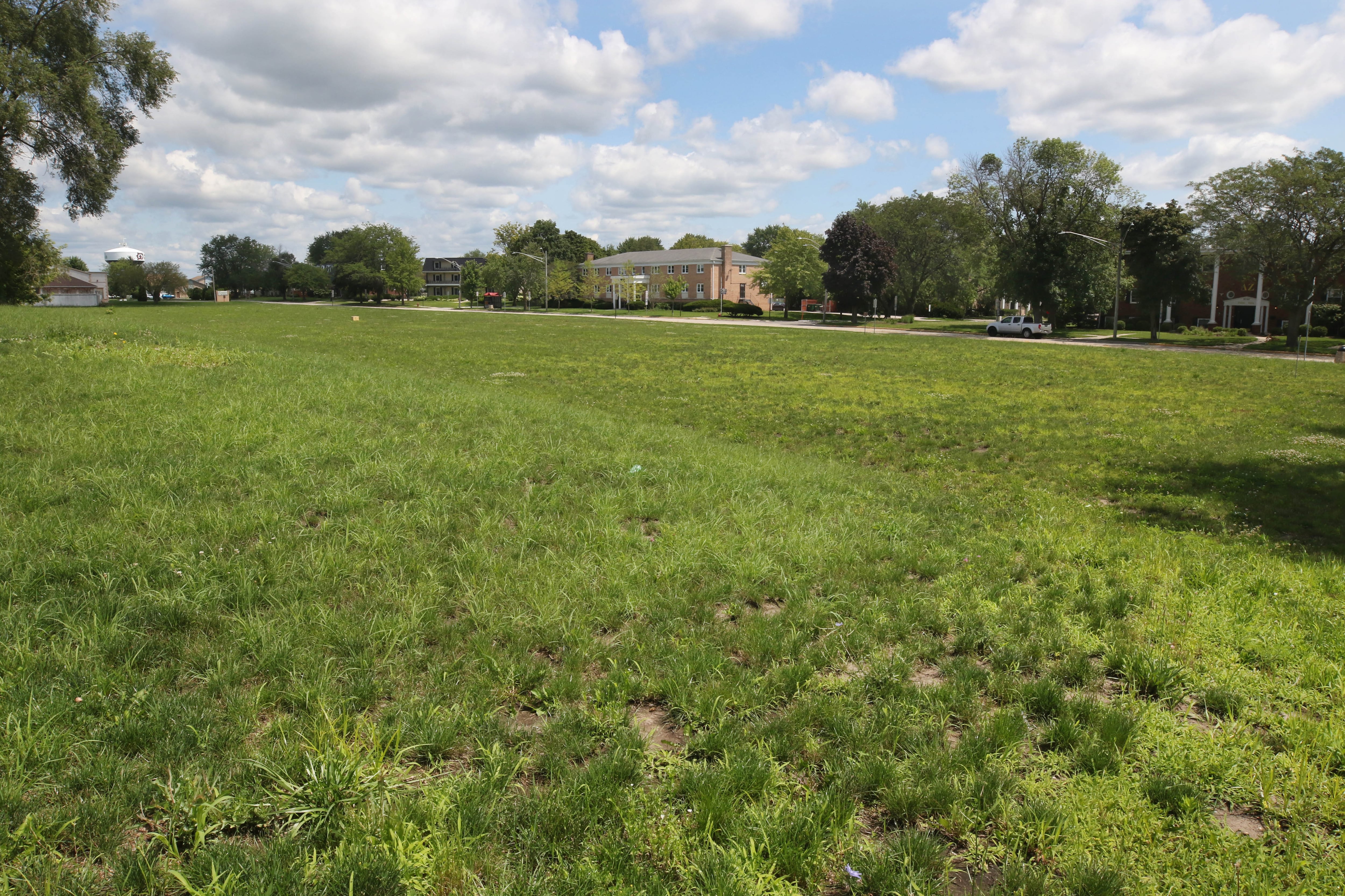 Looking east Thursday, July 18, 2024, over the parcel of land at the northwest corner of West Hillcrest Drive and Blackhawk Road in DeKalb. The lot is the proposed future site of the Northern Illinois University Greek Life Center.