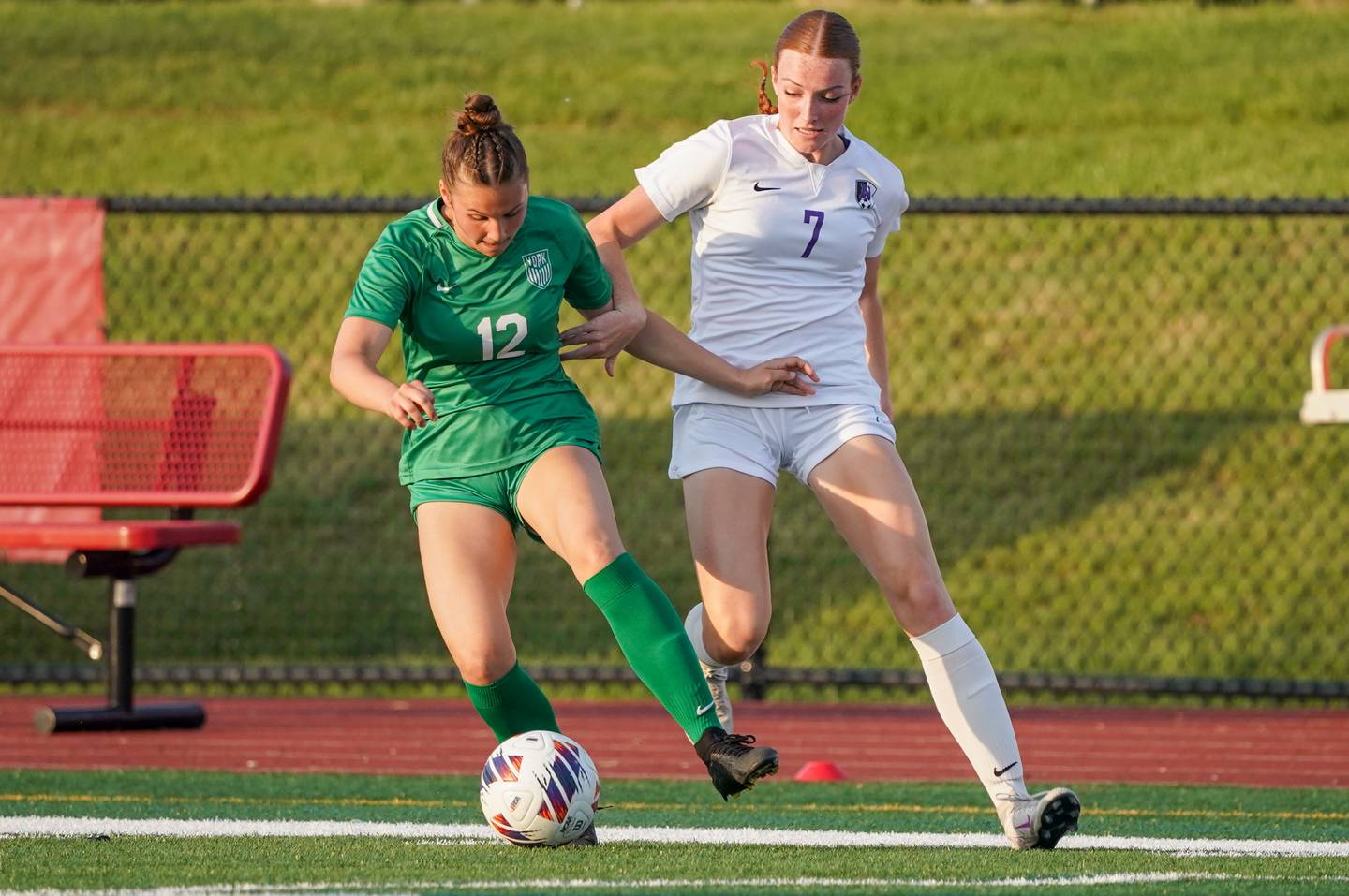 York’s Cate Carter (12) plays the ball against Downers Grove North's Audrey Anderson (7) during a Class 3A Hinsdale Central Sectional semifinal soccer match at Hinsdale Central High School in Hinsdale on Tuesday, May 21, 2024.