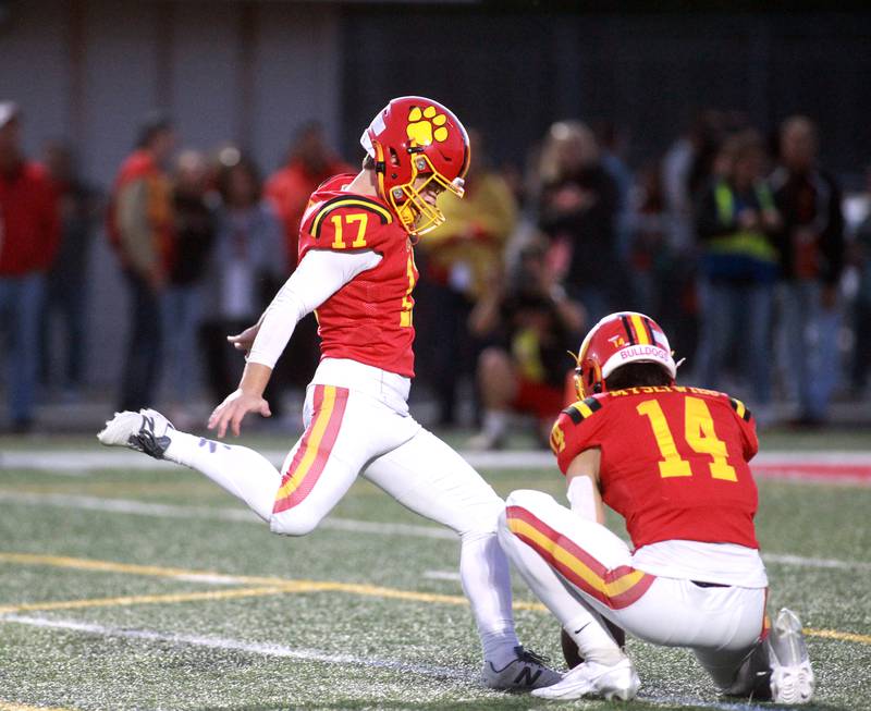 Batavia’s Caleb Peters kicks the extra point, assisted by ball holder Jake Mysliwiec, during a game against South Elgin Friday, Sept. 6, 2024 in Batavia.