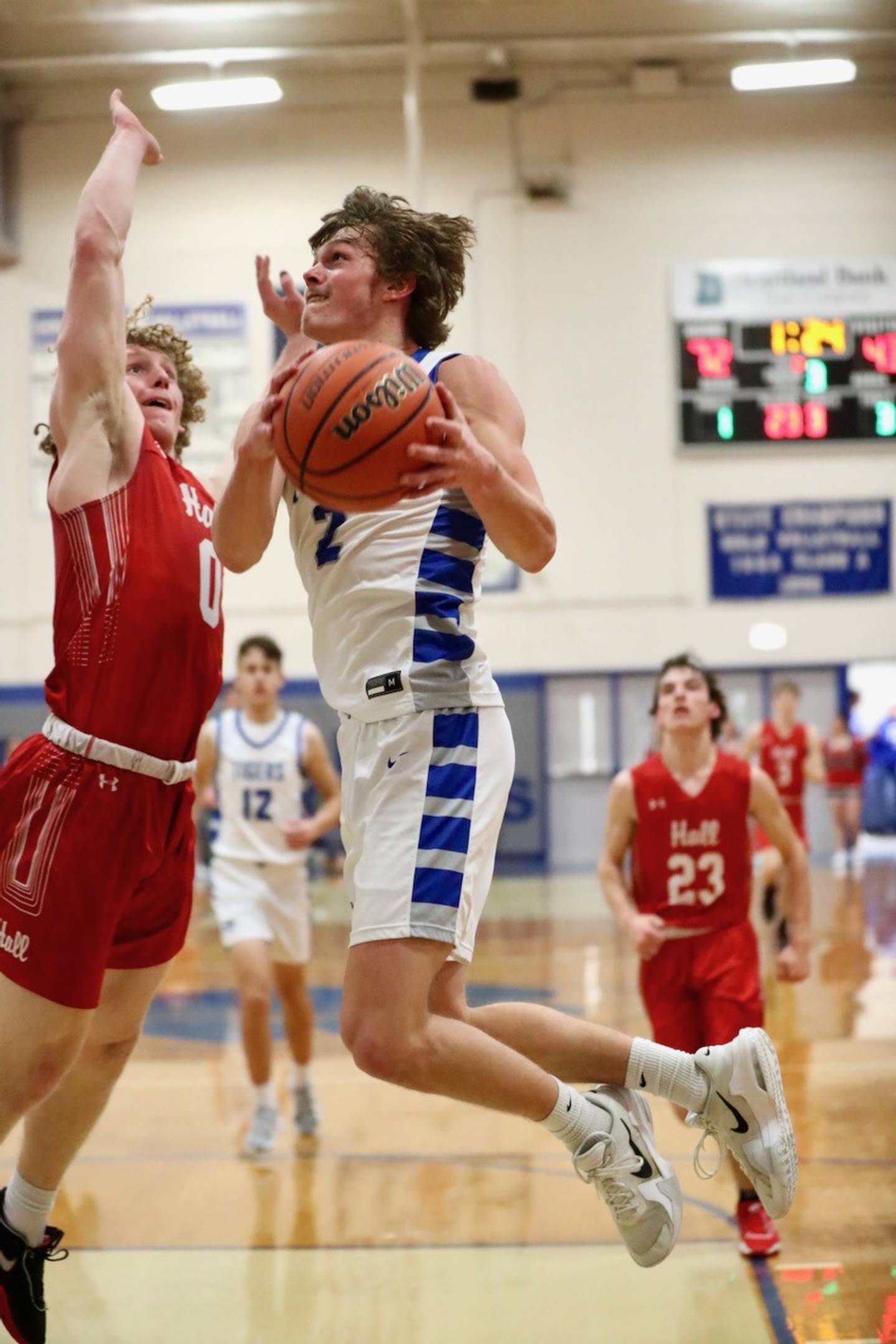 Princeton's Teegan Davis makes a drive against Hall's Mac Resetich in the second half Friday night at Prouty Gym. Davis scored 12 points to  become the 12th 1,000-point scorer in school history.