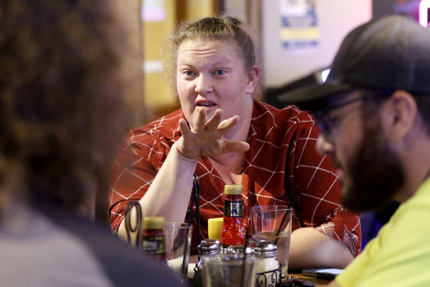 Stephanie Zapata and other members of the Phoenix, a recovery nonprofit, discuss their answer to a trivia question on Tuesday, Oct. 8, 2024, during a trivia night at Galati's Hideaway Restaurant in Cary. The recovery nonprofit takes people in recovery on outings such as hiking, bike riding, rock wall climbing, and trivia nights.