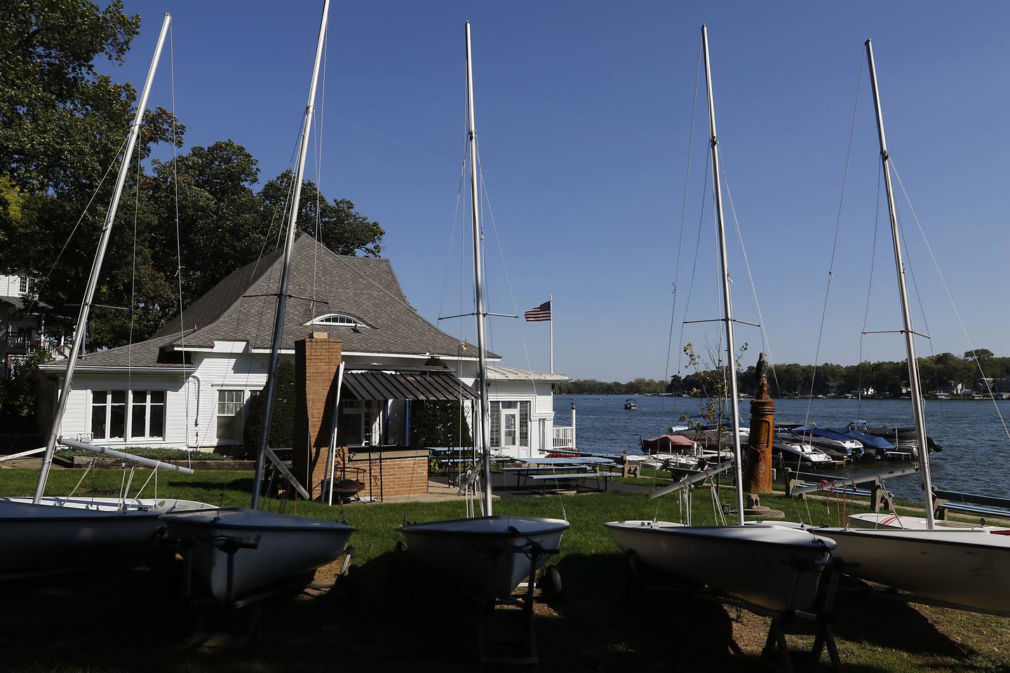 Pistakee Yacht Club member Jessica Boettcher give fellow member Mark Hoffman directions as he prepares to move a sailboat on Tuesday, Oct. 3, 2023. The yacht club has been parking boats and trailers on a lot next to the club since 1970m with a variance from the county. The Village of Johnsburg says they are in violation and have to move them boats and trailers from the lot.