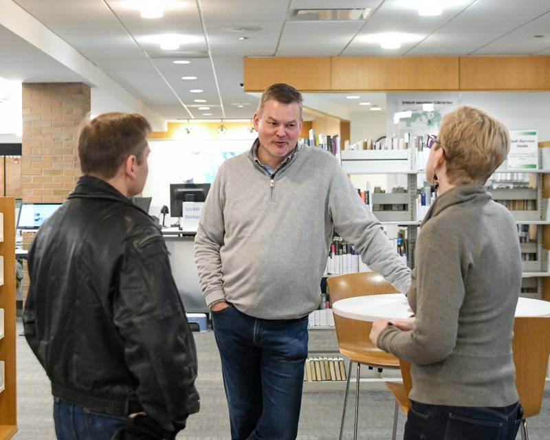 Downers Grove library board member Bill Nienburg, center talks with board member Carissa Dougherty, right, and community member Ed Pawlak during the coffee with board members event held on Saturday Feb. 17, 2024, at the Downers Grove library.