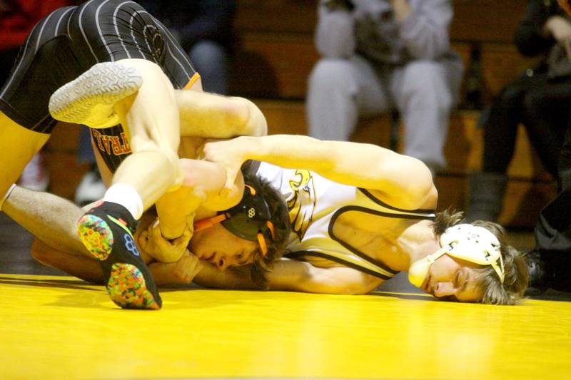 Jacobs’ Evander Lands, right, battles Crystal Lake Central’s Tommy Tomasello at 145 pounds in varsity wrestling Thursday at Algonquin.