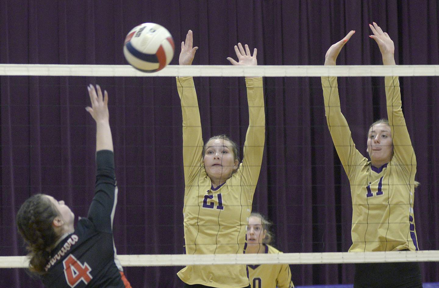 Serena’s Jenna Setchell and Kendall Whiteaker jump to block a shot by Woodland in the second set Tuesday at Serena.