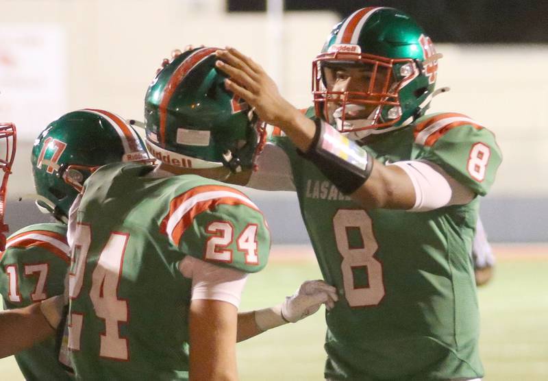 L-P quarterback Marion Persich congratulates teammate Easton Moriarity after scoring a touchdown against Ottawa on Friday, Sept. 13, 2024 at Howard Fellows Stadium.